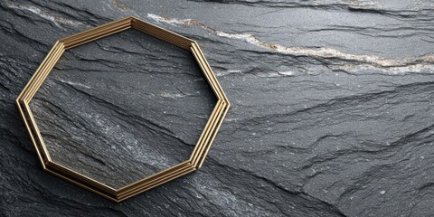 Golden geometric shape resting on textured dark stone with subtle gold vein