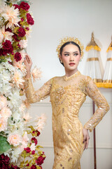 Indonesian Woman in Yellow Traditional Gown with Floral Decor