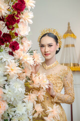 Indonesian Woman in Yellow Traditional Gown with Floral Decor