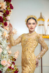 Indonesian Woman in Elegant Yellow Traditional Gown