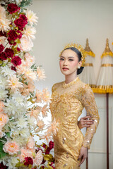 Indonesian Woman in Yellow Traditional Gown with Floral Decor