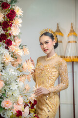 Indonesian Woman in Yellow Traditional Gown with Floral Decor