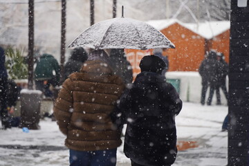 Almaty, Kazakhstan - 12.18.2025 : People are walking down the street in a heavy snowfall.