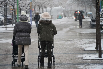 Almaty, Kazakhstan - 12.18.2025 : People are walking down the street in a heavy snowfall.