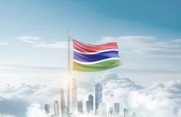The Gambia national flag waving in sky with modern building skyline. The Gambia national flag for independence day.