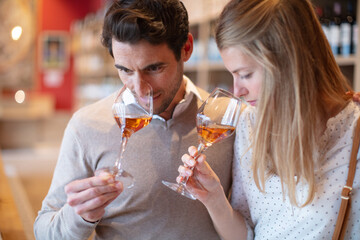 close up portrait of a couple tasting wine