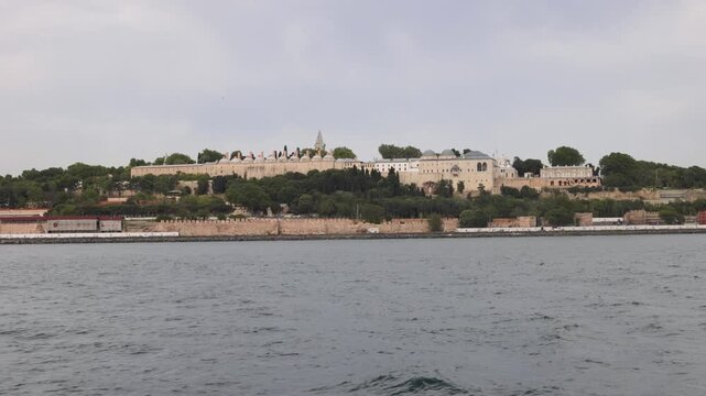Historic buildings of Hagia Sophia and Topkapi Palace on a hillside overlooking water in Istanbul.