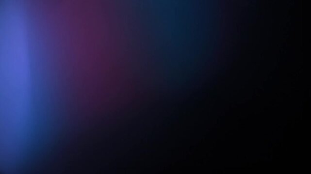 A slow, moody light leak with soft blue and purple tones gently drifts across a black background. This atmospheric overlay is perfect for creating a mysterious, calm, or introspective feeling.