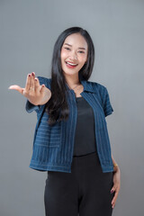 Smiling Asian Woman Offering Open Hand Gesture