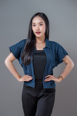 Confident Asian Woman Standing With Hands on Hips