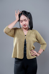 Indonesian Woman Touching Forehead in Thoughtful Expression