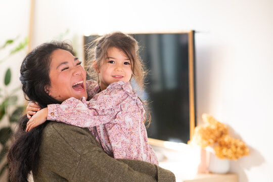 mother holding her young daughter in her arms