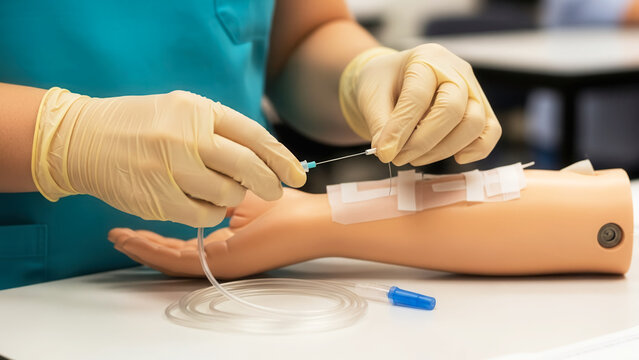 Gloved hands holding IV needle, medical training demonstration with mannequin arm, healthcare education and skill development