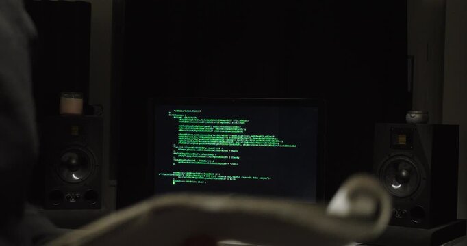 Cinematic shallow-focus shot of a person writing in a notebook with a blurred code-filled monitor behind&mdash;concept for replacing manual protocols with AI automation, documentation, and productivity.