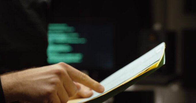 Cinematic close-up of hands signing paperwork with a blurred code-filled monitor behind&mdash;concept for AI contracts, copyright agreements, licensing, legal compliance, and digital rights management.