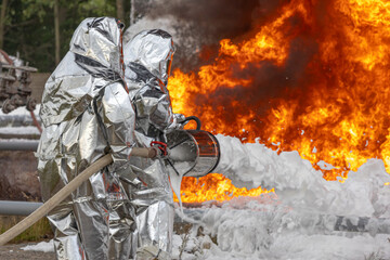 Firefighters use a foam generator to supply foam to extinguish the fire. A fire at the plant caused by the ignition of an oil product. Firefighters extinguish a fire at an oil refinery.