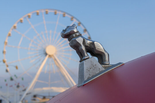 A bulldog on the hood of a Christmas-themed Mack truck in Baku. The Ferris wheel is in the background.