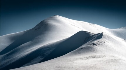 Majestic snow-covered mountain peaks under a deep blue sky, showcasing the serene beauty of an untouched winter landscape.