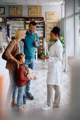 Happy family talking to their pharmacists in drugstore.