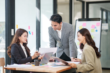 A group of Asian businessmen stood and discussed ways to solve investment business problems.