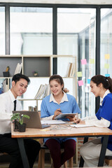 A lone Asian male doctor is working in a hospital conference room.