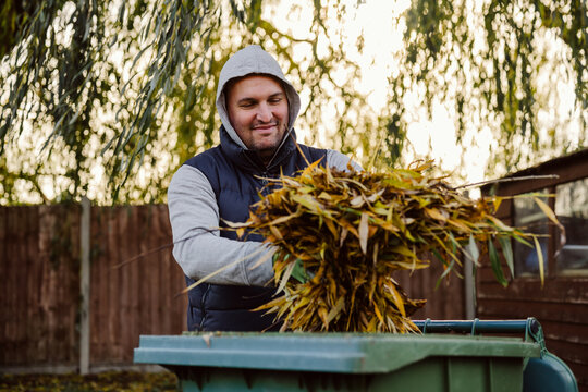 Gardener doing recycling yellow autumn leaves outdoors