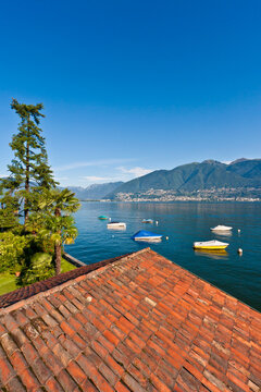 Lake Maggiore view with boats and mountains from Vira in Ticino