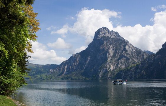 Boat on Traunsee lake with Traunstein mountain in Salzkammergut Austria
