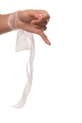 Woman's hand shows a thumbs down gesture with a white, sheer ribbon tied around her wrist