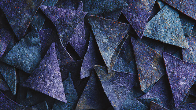 Blue corn tortilla chips flat lay, triangle shape, rustic texture