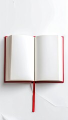Red book open, white paper backdrop