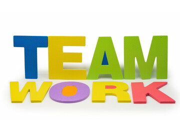 Bright EVA foam letters spelling teamwork on a white background, representing collaboration, unity, leadership, and effective cooperation in business, education, or team culture themes.