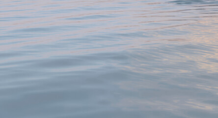 Calm ocean water with gentle ripples at sunset