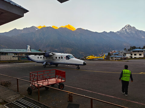 Lukla, Nepal - October 13, 2025: Sita Air plane is stationed at Lukla Airport, with stunning mountain scenery and vibrant colors illuminating the landscape