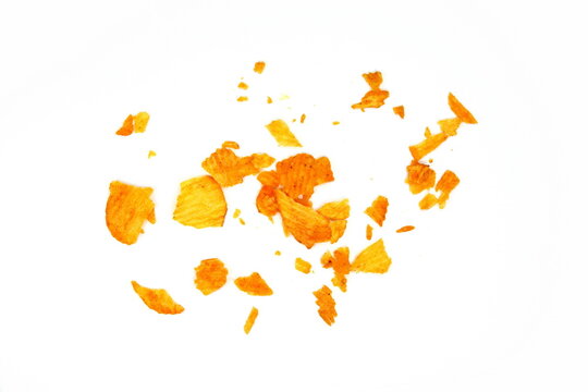 Potato chips crumbs and leftovers isolated over the white background