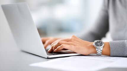 Professional accountant working diligently on laptop, with hands on keyboard, surrounded by financial documents, showcasing productivity and focus in a modern office environment