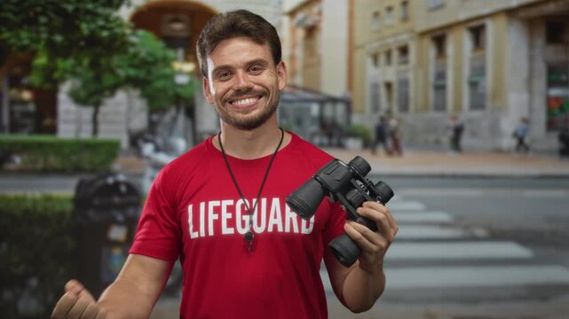 Man lifeguard in red shirt holding binoculars and waving arm on city street crosswalk; confidence duty community.