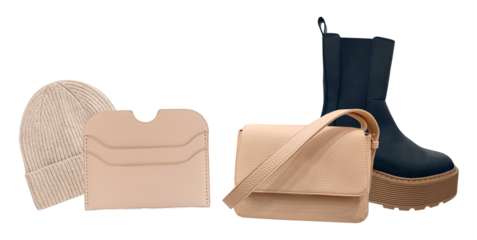 stylish beige knitted beanie hat with a folded brim, a nude card holder, a satchel bag and chunky platform chelsea boots photograph