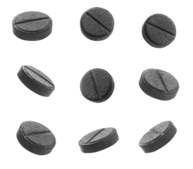 high-resolution photograph of nine activated charcoal tablets against a plain transparent background, suitable for advertising detox supplements and natural remedies