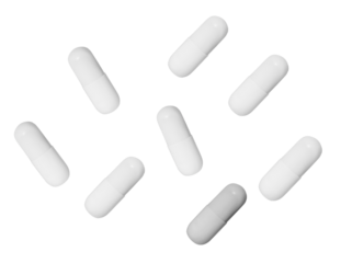 top-down photograph of multiple white capsules scattered across a black surface, ideal for depicting themes related to medicine and pharmaceuticals.