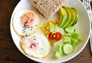 traditional breakfast with fried egg and salad