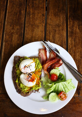 traditional breakfast with fried egg and salad