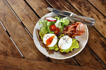 traditional breakfast with fried egg and salad