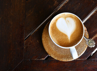 cup of cappuccino on wooden table for coffee break