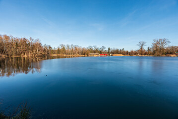 Partly icebound lake in Park Bozeny Nemcove public park in Karvina city in Czech republic
