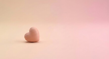 A single, small, pastel pink heart-shaped candy on a soft, gradient background