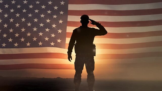 Dramatic backlit silhouette of a patriotic soldier saluting against the massive American flag overlay during a solemn, hazy desert sunset.