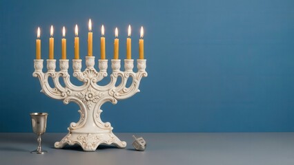 White Hanukkah menorah with lit candles on gray table
