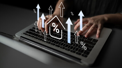 An image showcasing hands typing on a laptop, overlaid with growth arrows and a house icon, symbolizing economic advancement, investment analysis, and market trends. Gantry