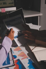 Above table with finance papers, graphs and big data during teamwork meeting with accounting or marketing team discussing budget, strategy or growth development. Closeup of SEO team doing research